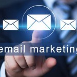 "email marketing" words with hand pointing on envelope