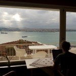 A guy working with laptop with amazing view on window